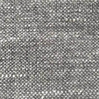 Woven fabric texture, muted gray with heathered effect, displaying a dense grid pattern and speckled appearance; label reads “ditre italia martin 107”.